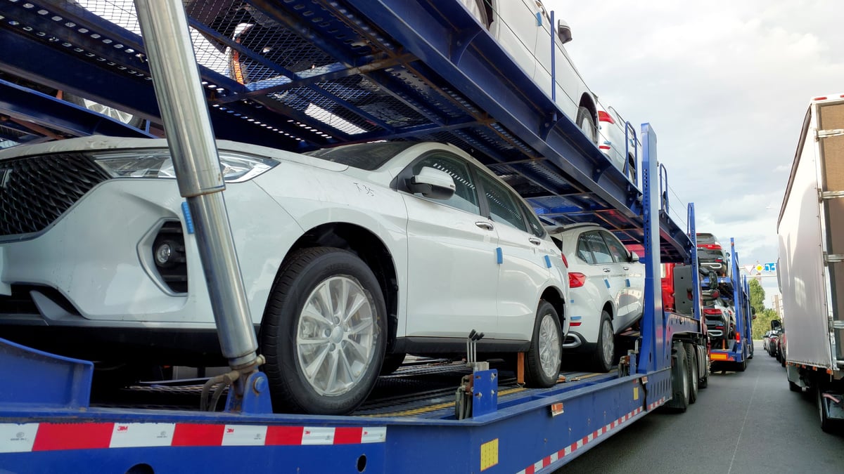 Car transporters loaded with cars on highway
